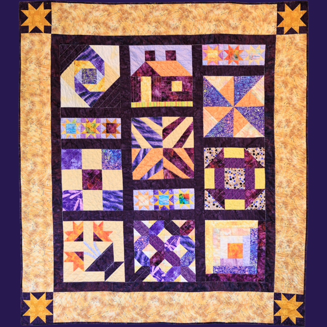 A mostly purple and yellow patterned quilt.