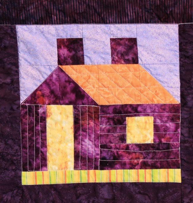 A quilt block with the shape of a house