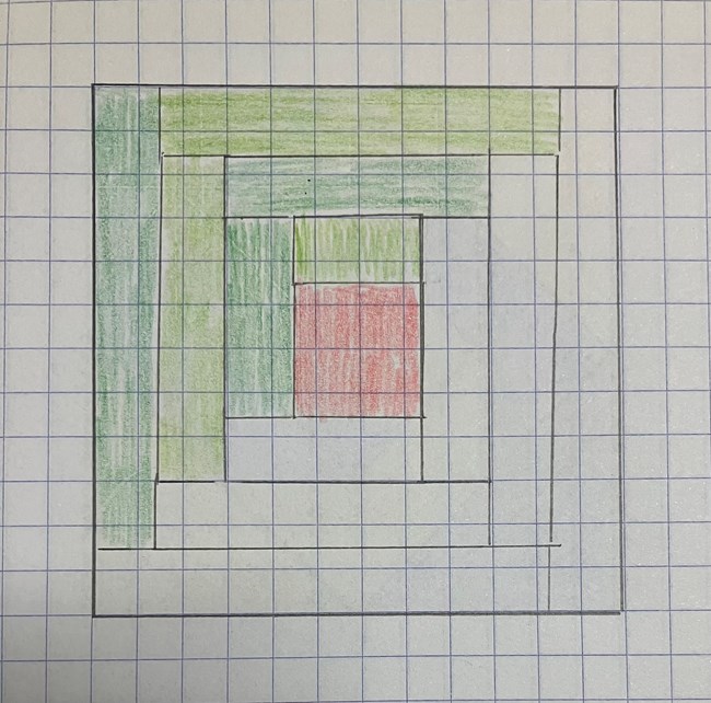 A draft of gridded paper of a log cabin quilt block.