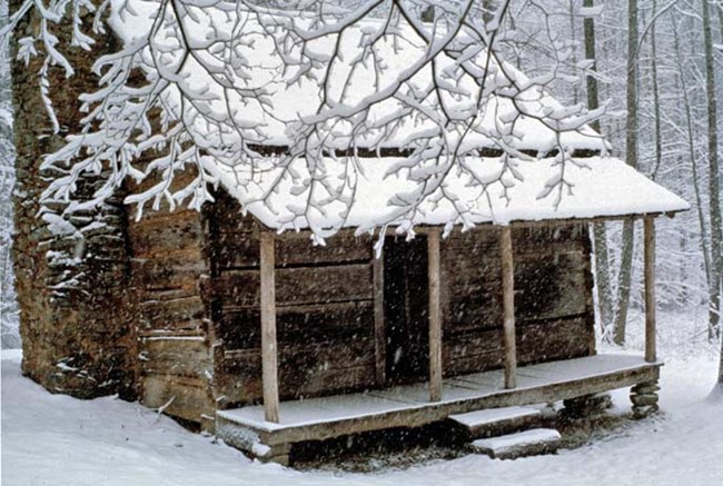 Snow blankets the John Ownby cabin during a winter storm.