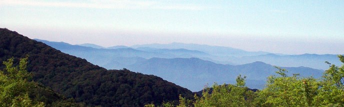 view from a mountain top with distant mountain ridges stretching to the horizon