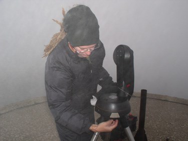 Kate sets up night sky monitoring equipment.