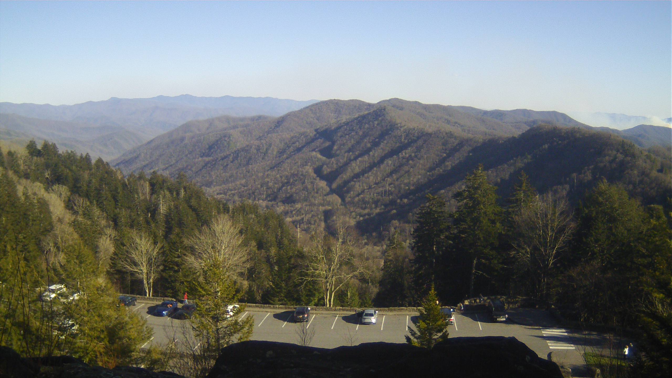 2022.03.26 Photo of Deep Creek area fires from Newfound Gap webcam Parking lot view of mountains and distant smoke.