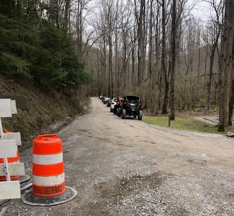 Greenbrier Road near the Picnic Area, 2021 Gravel road with traffic cones on left and vehicles parked along the road on the right side.