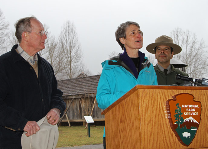 Secretary Jewell speaks at podium while Senator Alexander and Superintendent Pedro Ramos listen.