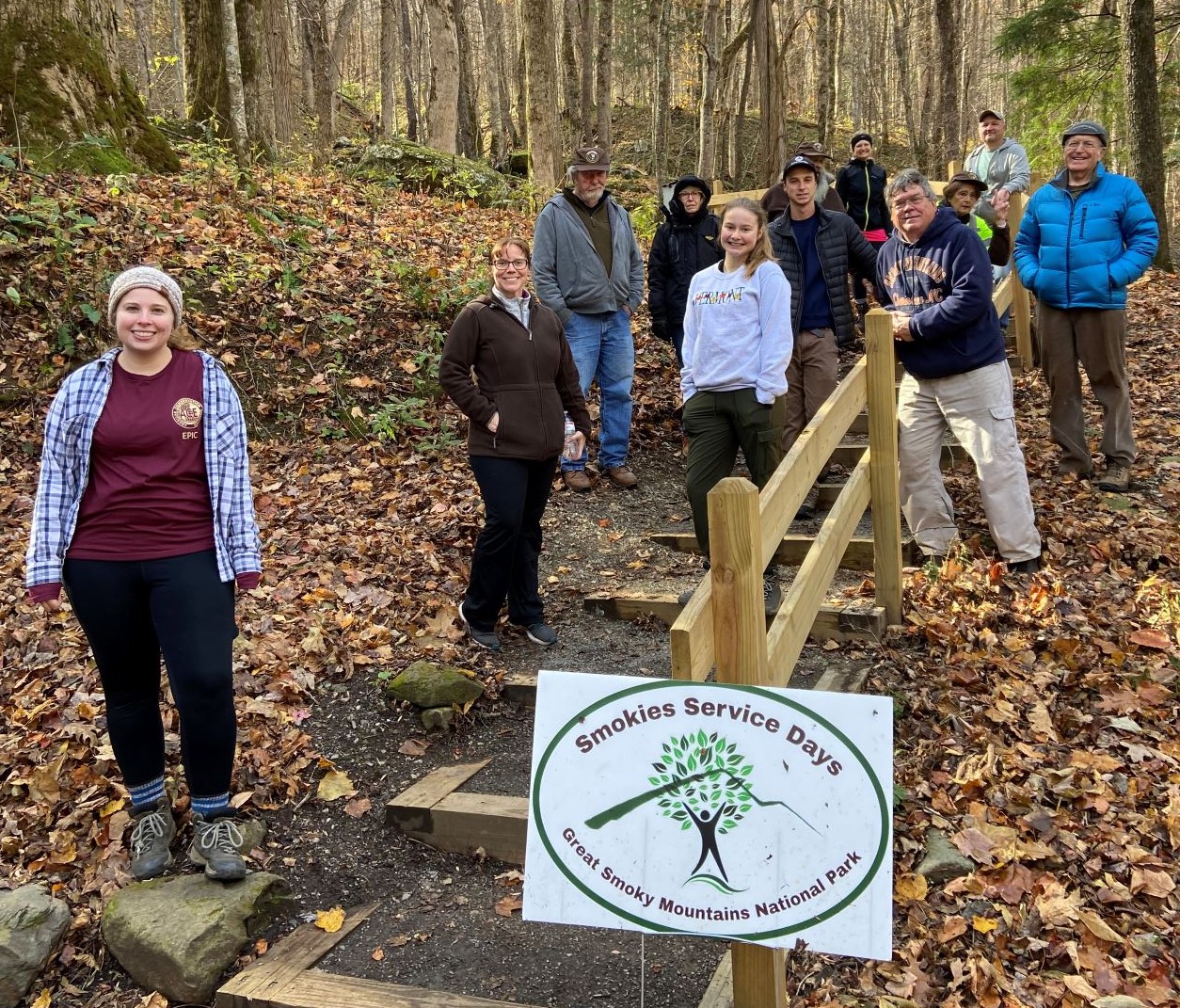 Smokies Service Day Campground CleanUp_2021 A group of people standing along a set of outdoor stairs amid fallen leaves and mostly bare trees