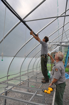 Maintenance crews work on the new greenhouse.