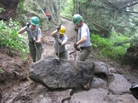 Crew moves large rock for staircase