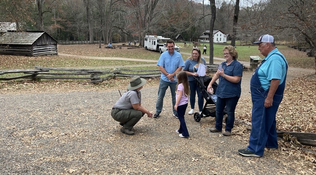 Park ranger speaking with a family at Cable Mill in Cades Cove