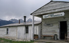 menors ferry story with tetons in background and storm rising.