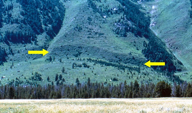 Teton fault scarp - a steep slope on the side of the mountain formed due to earthquakes breaking the surface