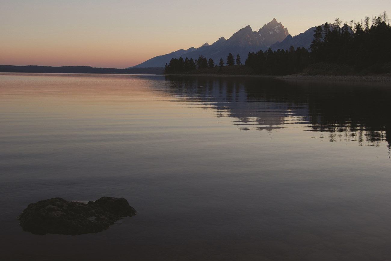 Sunset on Jackson Lake with the Teton Range to the right. The air looks a bit hazy.