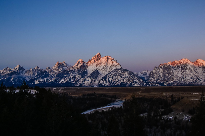 Snake River Overlook Teton range with alpenglow sunrise on the mountain peaks from Snake River Overlook.