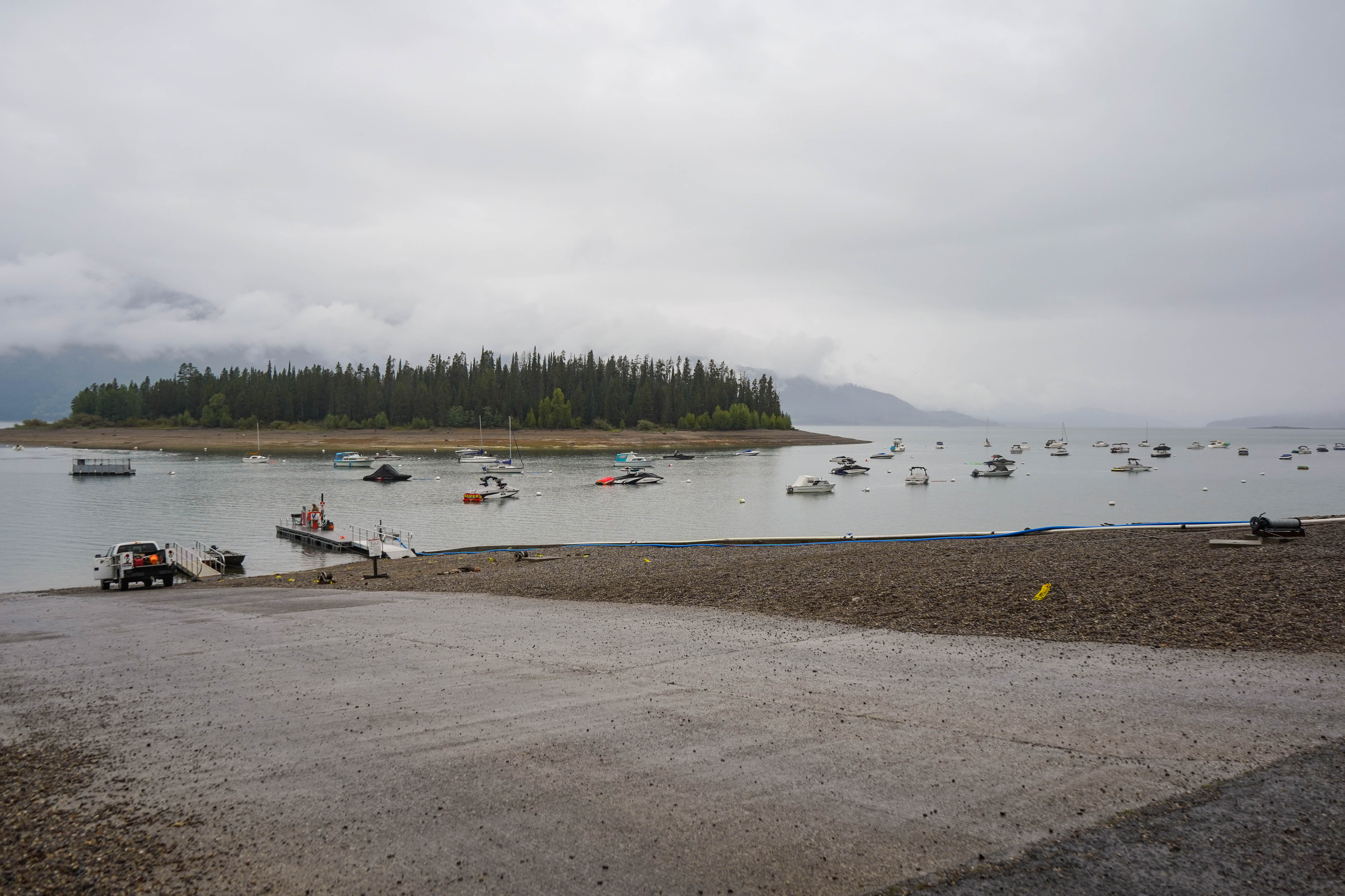 boats on a lake with a ramp leading to the lake