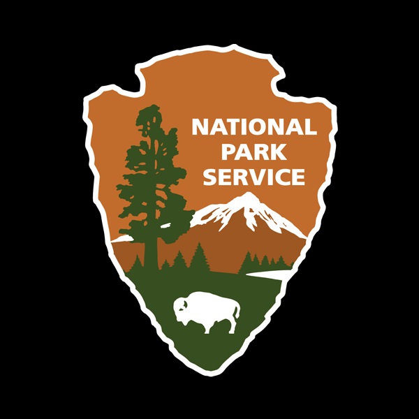 National Park Service Arrowhead with bison, tree, mountain, and National Park Service written in text inside the arrowhead.