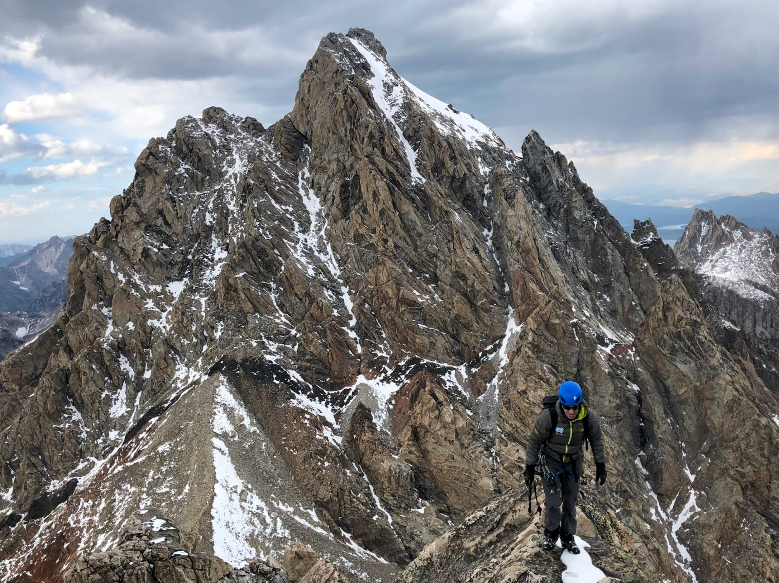 Climber Climber in the mountains with the Grand Teton behind.