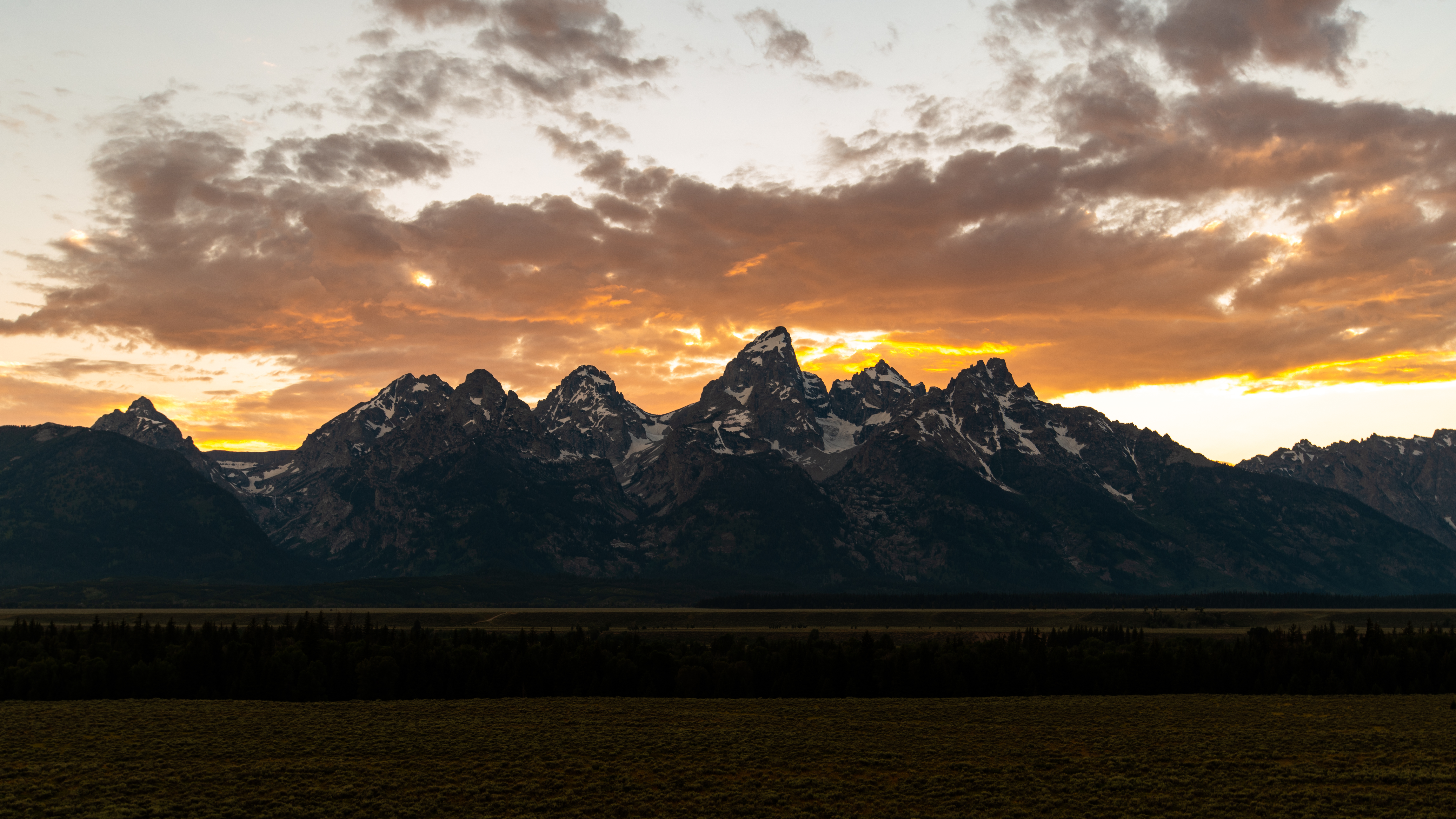 Panoramic view of the Teton Range at sunset. Panoramic view of the Teton Range at sunset.