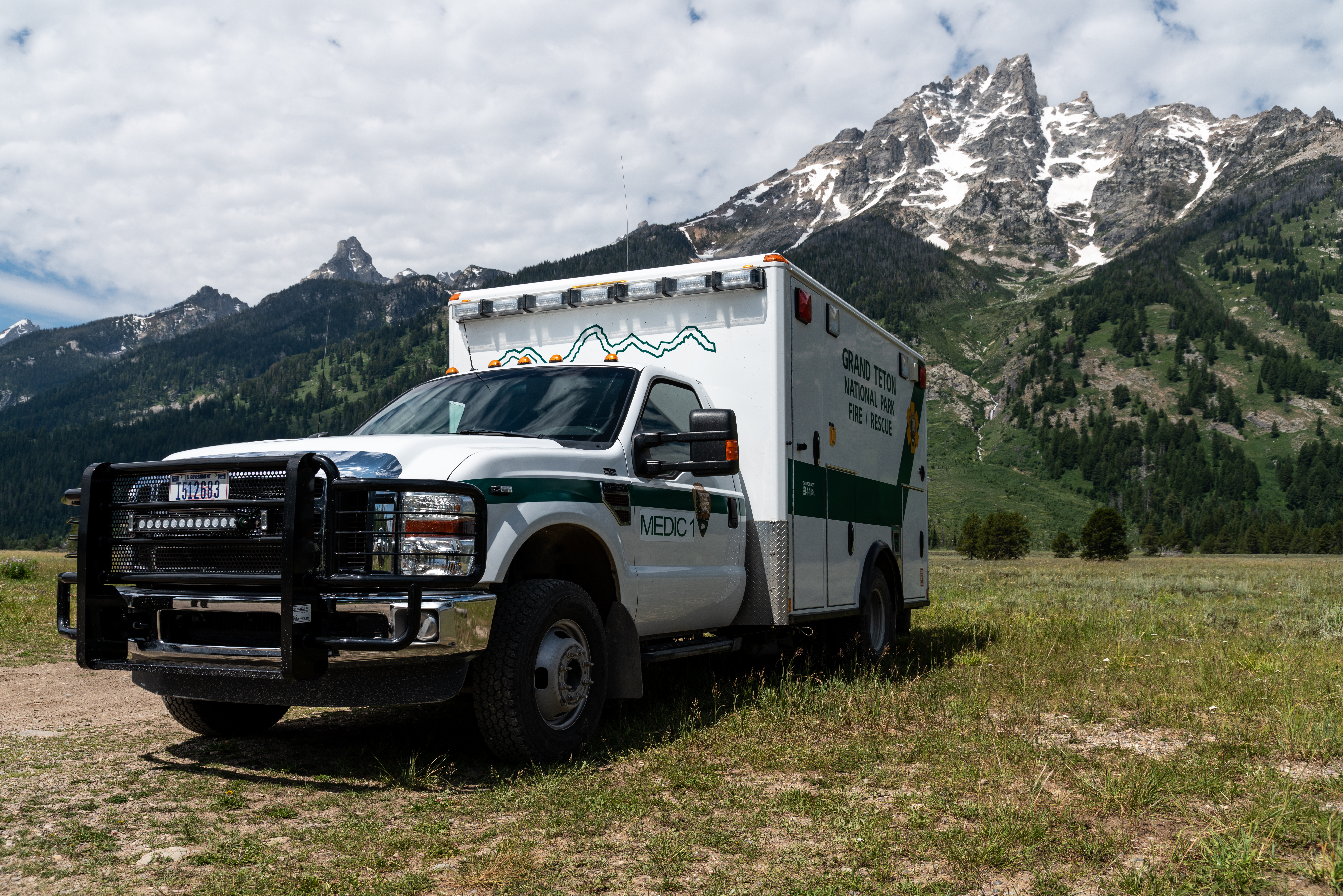 Ambulance in front of Mount Teewinot at the Jenny Lake Ranger SAR Cache