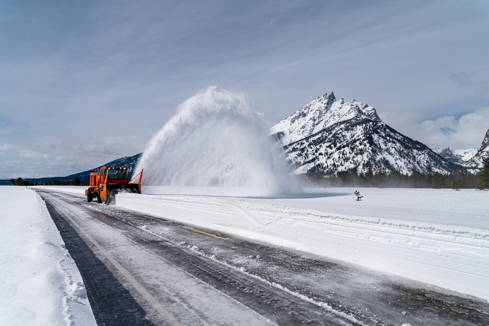Spring plowing on Teton Park Road Rotary snow removal equipment removes snow from the Teton Park Road with the Teton Range in the background