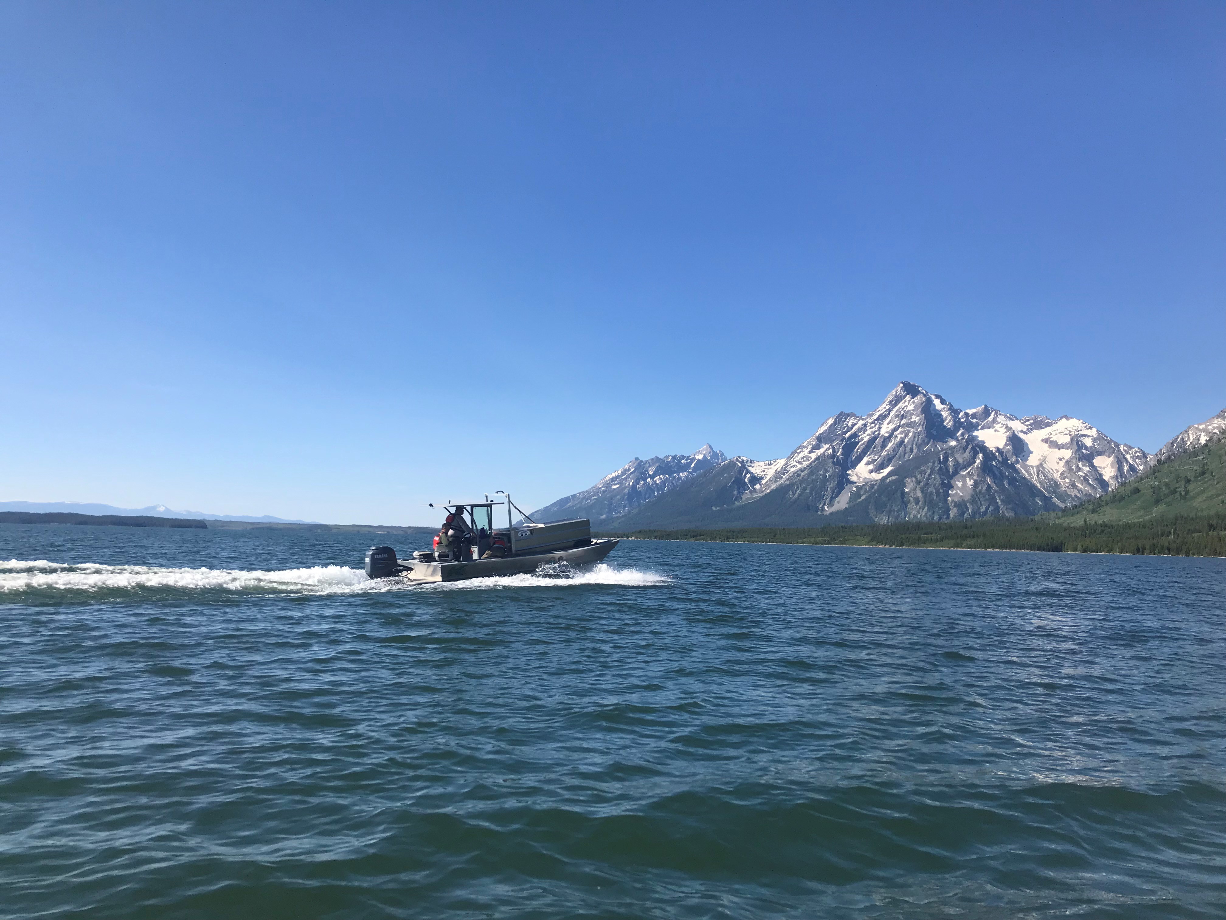 a boat moving across a lake