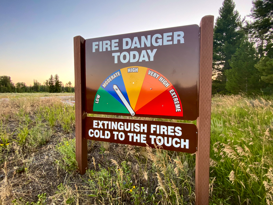 Moderate Fire Danger Fire danger rating sign with arrow pointing to moderate