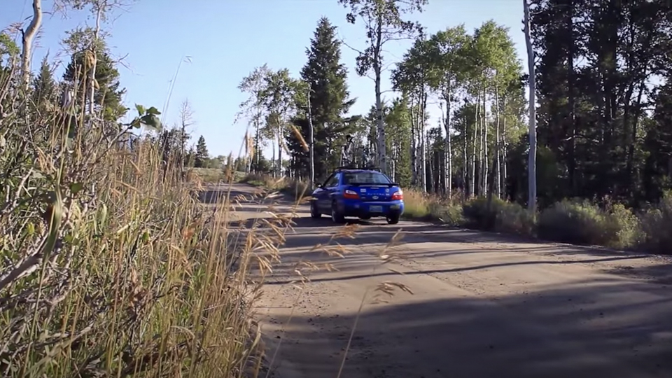 Moose-Wilson Road Vehicle driving on dirt section of the Moose-Wilson Road