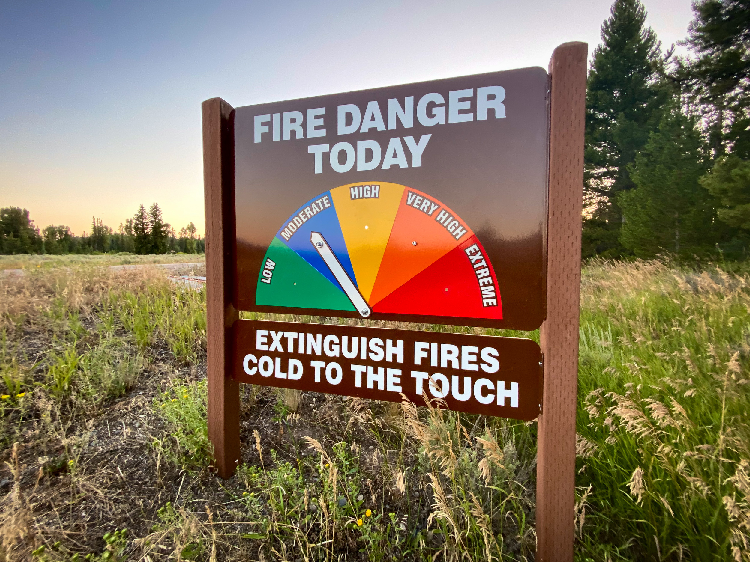 Moderate Fire Danger Brown sign reads "Fire Danger Today" with arrow pointing to "Moderate" and message below that reads "Extinguish Fires Cold to the Touch."