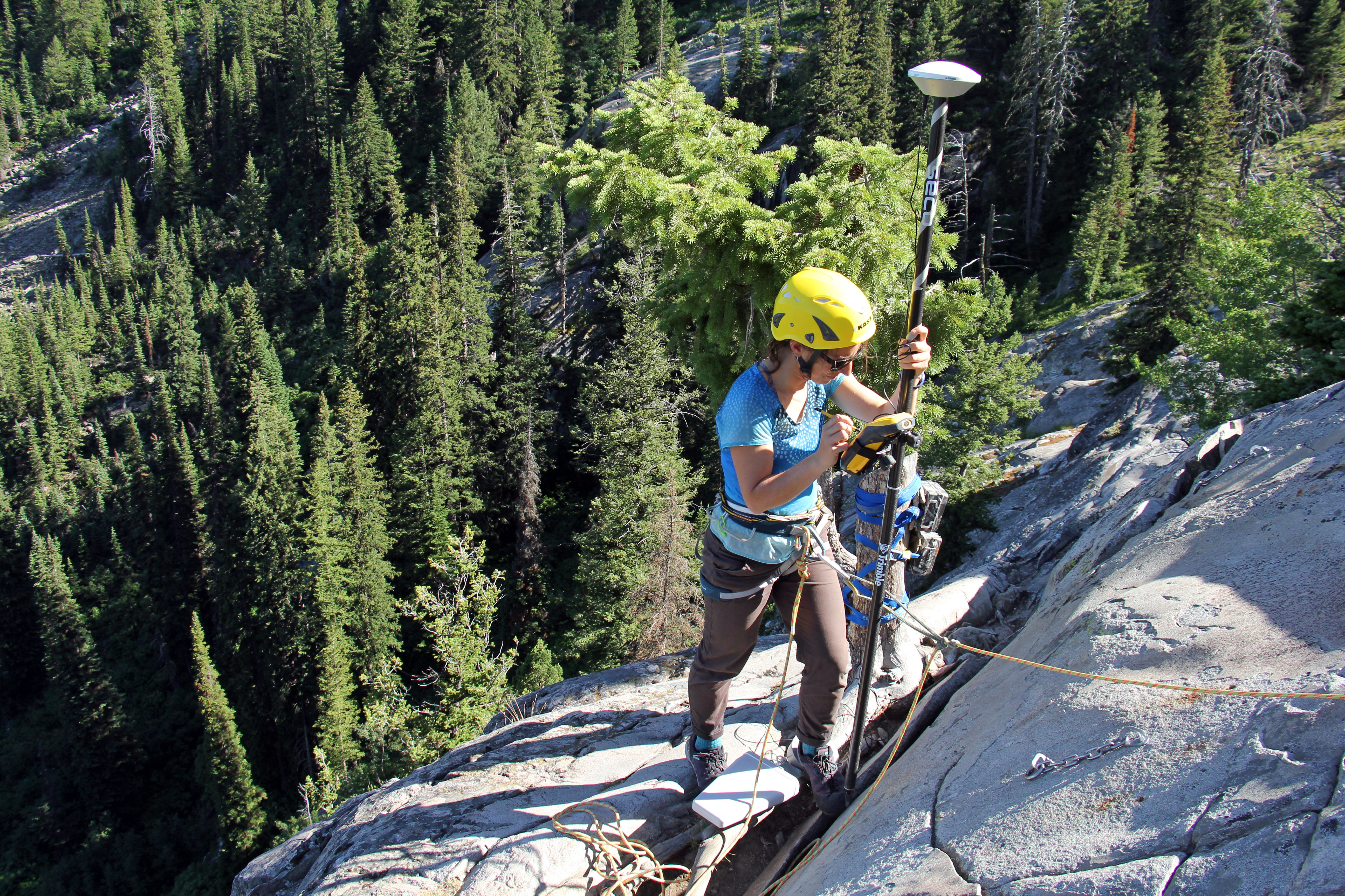A Grand Teton National Park physical scientist takes a GPS reading along the crack in the rock buttress. A Grand Teton National Park physical scientist takes a GPS reading along the crack in the rock buttress.