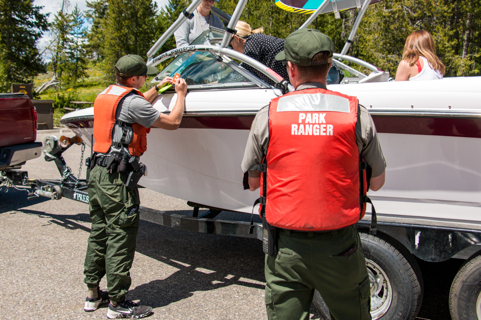 Park ranger provides vessel safety inspection and information to park visitors boating