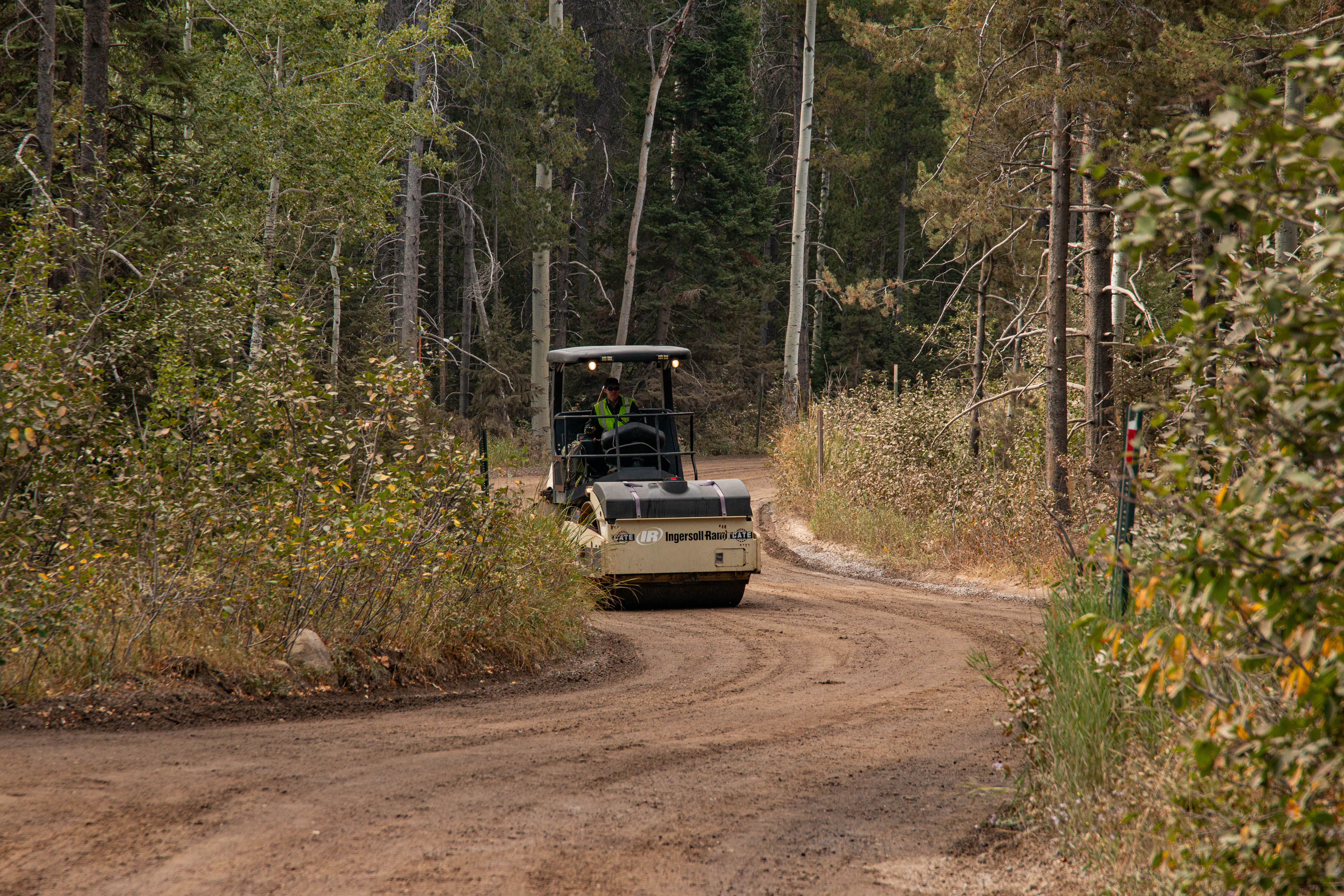 a roller travels down a dirt road