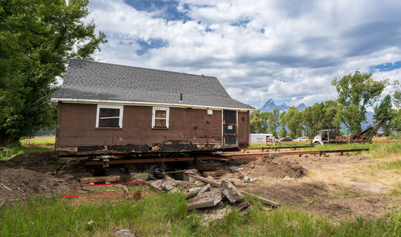 House lifted on metal rails about to be moved