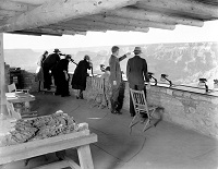 Naturalist Edwin McKeee shows the canyon to visitors from the parapet of Yavapai Observation Station. Circa 1930. NPS Photo
