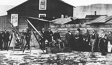 Black and white photo of a group of people with telescopes.