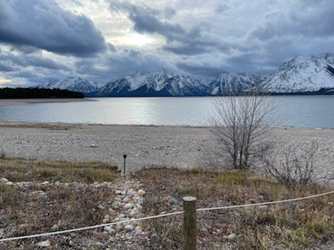 Colter Bay Picnic Area View from near ceremony location View down a path to a rocky beach leading to a lake with the Teton range in the background.