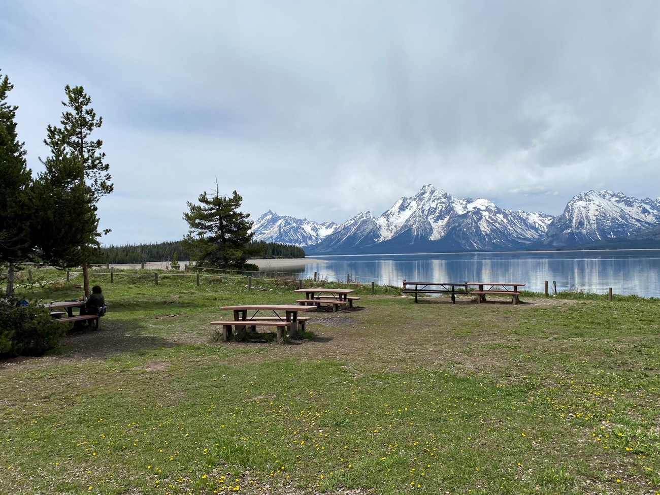 Picnic tables set in front of a view of Mount Moran across Jackson Lake