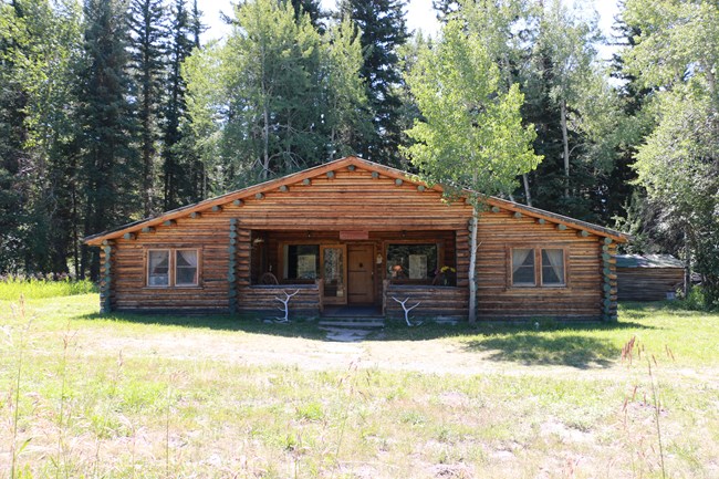 A log cabin near the woods.