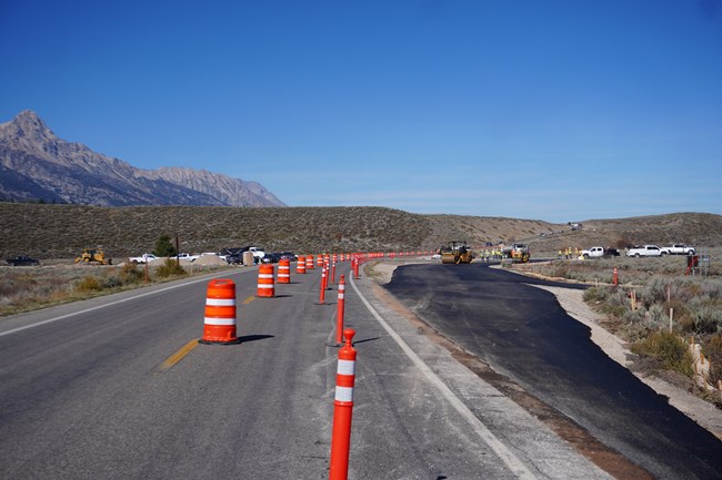 North facing view of Teton Park Road with a temporary detour being installed near the site of a future roundabout.