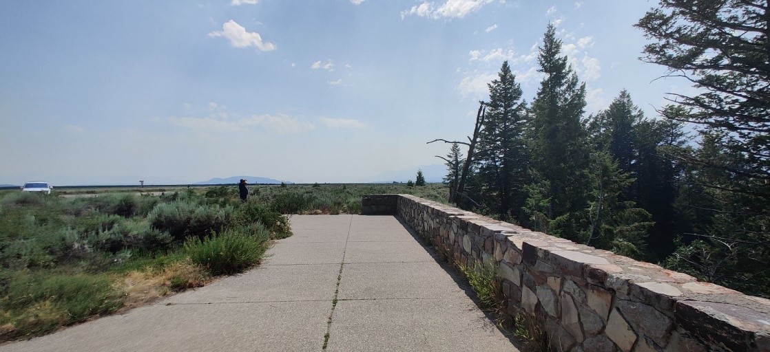 Snake River Overlook view of pathway and rock wall near ceremony location View of the paved pathway and a rock wall near the ceremony location.