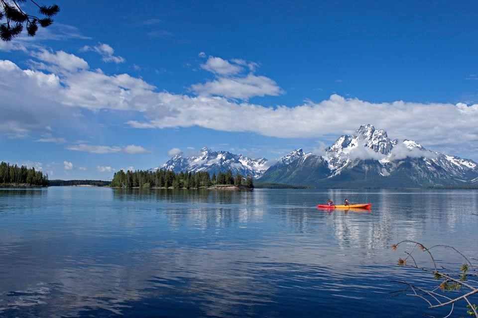 A kayak on a lake with mountains in the background.