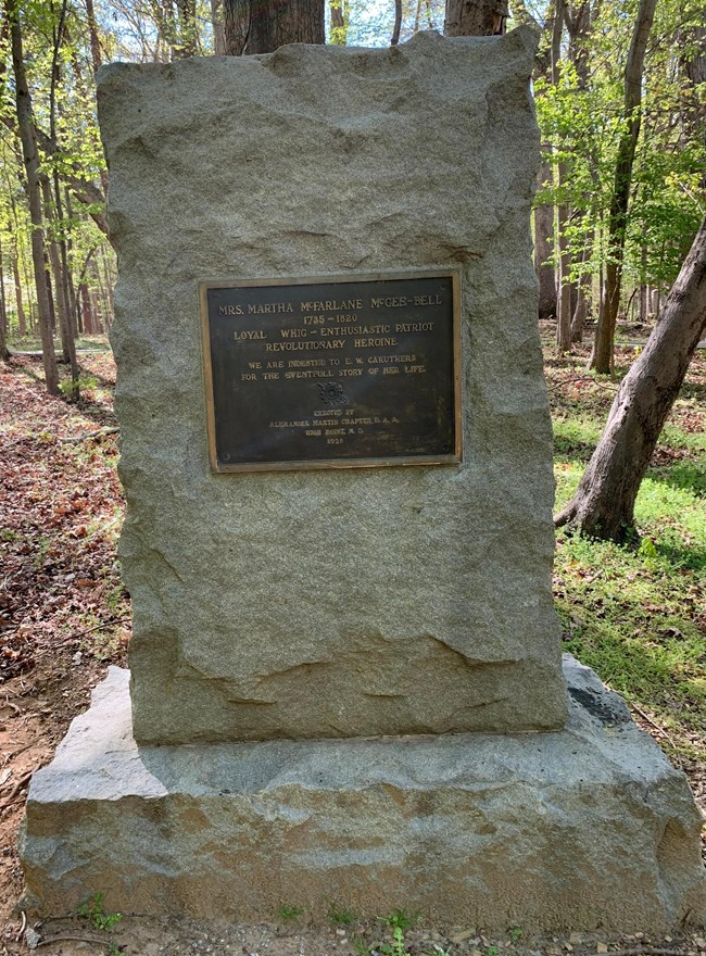 Rectangular rough stone monument with brass plaque for Martha McFarlane McGee-Bell