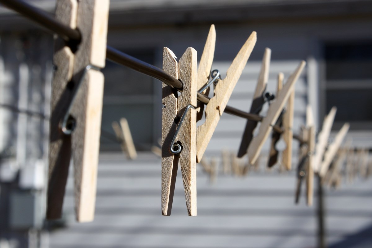 Wooden clothes pins attached to a clothes line. Wooden clothes pins attached to a clothes line.