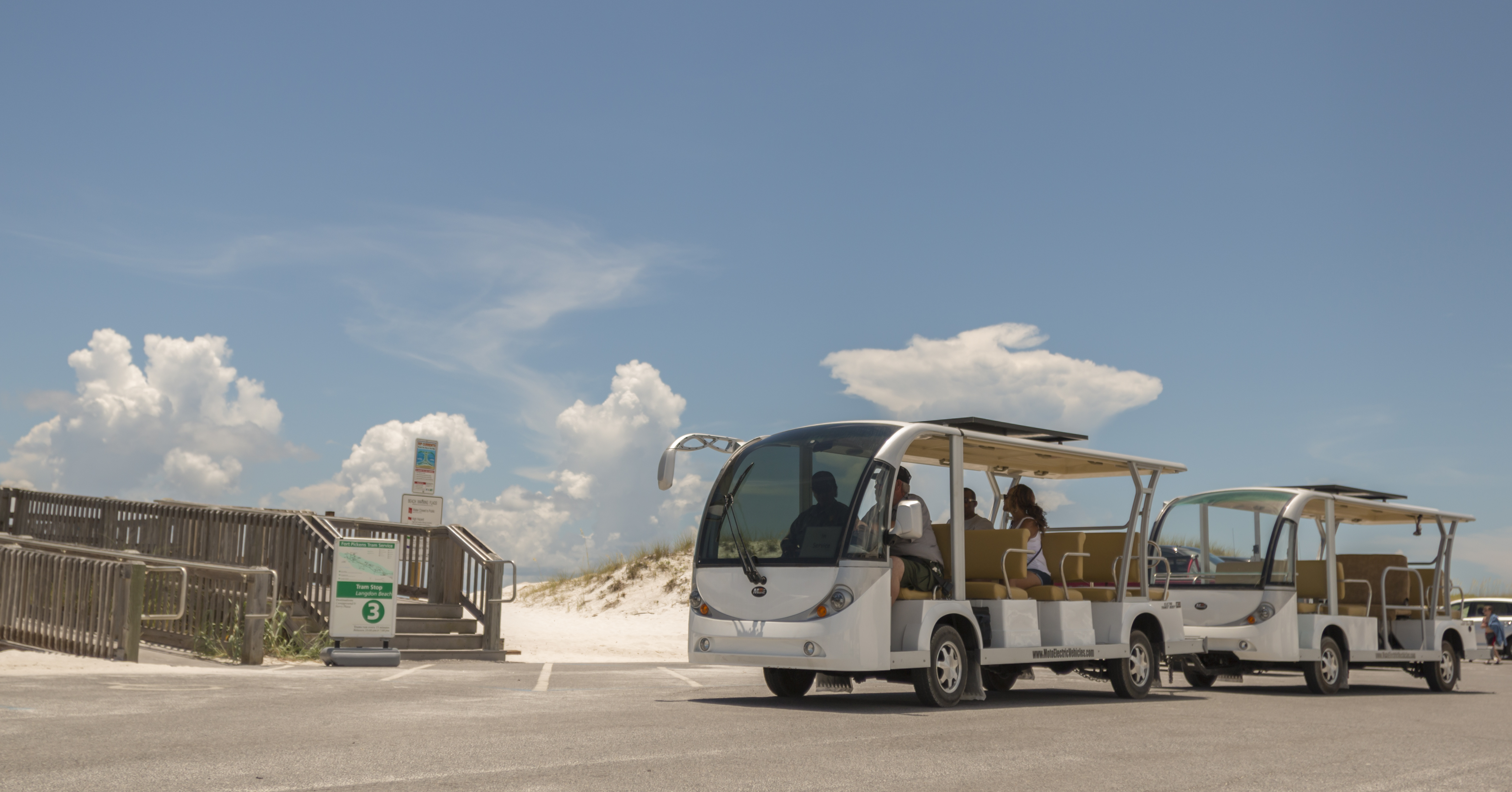 Electric Tram at Langdon Beach in the Fort Pickens Area. An electric tram vehicle in a parking lot at the beach.