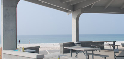 A beach scene from beneath a pavilion. A beach scene from beneath a pavilion.