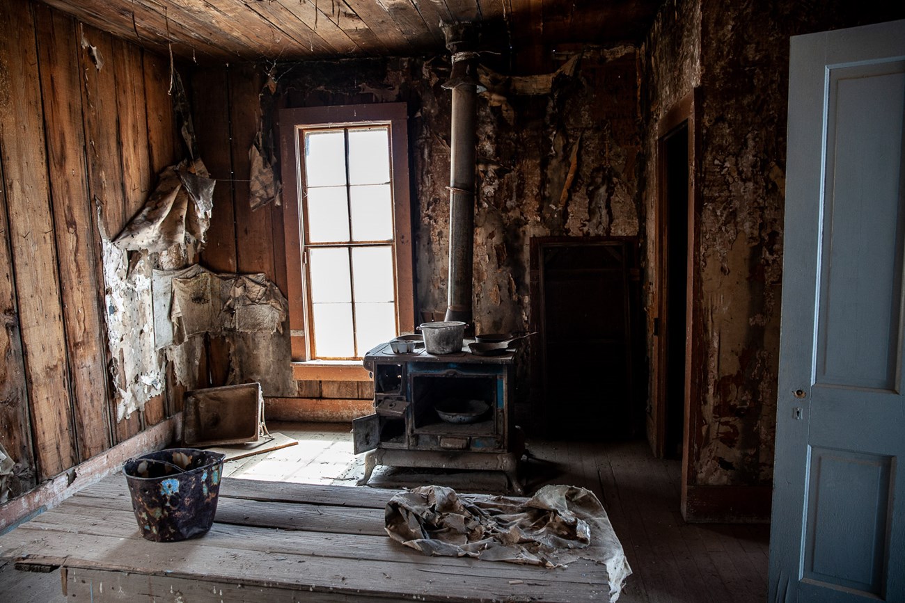 A historic cabin interior is a state of disrepair
