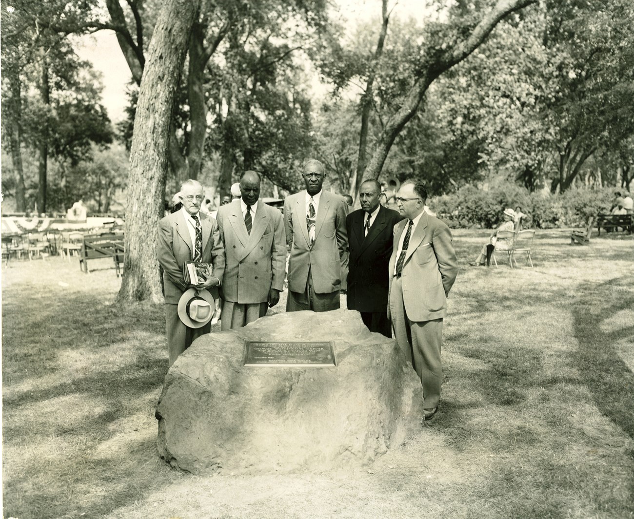 Five men standing around a memorial boulder at the park dedication ceremony in 1953.
