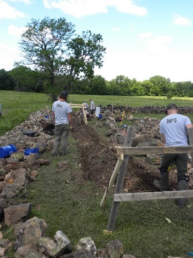 Great American Outdoors Act (GAOA) funding will preserve historic walls of Carver Family Cemetery at George Washington Carver National Monument. Skilled Masons wearing NPS shirts are repairing a cemetery wall at George Washington Carver National Monument.
