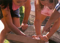 Kids washing laundry with scrub board