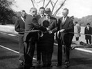 Historic photo of President Eisenhower cutting the ribbon as the parkway opens
