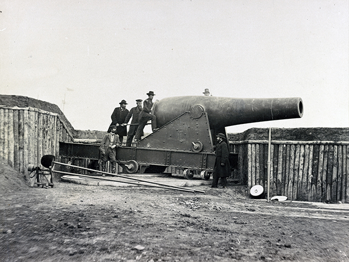 Six men load a canon at Battery Rodgers