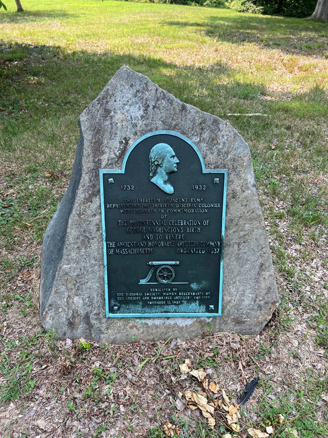 A plaque attached to a stone.